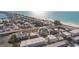 Expansive aerial showcasing a home with a rooftop deck nestled in a coastal community at 111 6Th N St, Bradenton Beach, FL 34217
