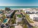 Stunning aerial view of a coastal home, showing the pool, beach access, and nearby ocean at 111 6Th N St, Bradenton Beach, FL 34217