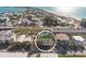 High-angle view highlighting a property with rooftop terrace surrounded by lush landscaping at 111 6Th N St, Bradenton Beach, FL 34217