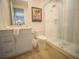 Stylish bathroom featuring a vanity, toilet, and walk-in shower with blue and white tiling at 111 6Th N St, Bradenton Beach, FL 34217