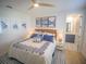 Charming bedroom featuring a queen bed with blue accents and nautical-themed decor at 111 6Th N St, Bradenton Beach, FL 34217