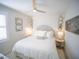 Bright bedroom with a queen bed, ceiling fan, and decorative wall mirrors at 111 6Th N St, Bradenton Beach, FL 34217