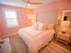 Bright bedroom with a queen bed, ceiling fan, and unique white wall decorations at 111 6Th N St, Bradenton Beach, FL 34217