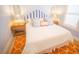 Comfortable bedroom featuring a queen-sized bed with a striped headboard and stylish nightstands at 111 6Th N St, Bradenton Beach, FL 34217