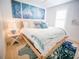 Serene bedroom featuring white walls, wood floors, and a queen-sized bed with blue accents at 111 6Th N St, Bradenton Beach, FL 34217