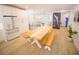 Bright dining area showcasing a long wooden table with bench seating and modern appliances at 111 6Th N St, Bradenton Beach, FL 34217