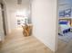Hallway featuring wood floors and stylish decor with a view of a bedroom and kitchen at 111 6Th N St, Bradenton Beach, FL 34217