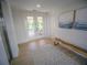 Hallway with light colored wood flooring, modern art, and an entrance to the outdoor lounge at 111 6Th N St, Bradenton Beach, FL 34217
