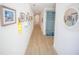 Hallway featuring wood floors and nautical-themed decor and a blue hallway seat at 111 6Th N St, Bradenton Beach, FL 34217