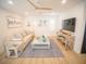 Bright living room with modern decor, comfortable seating, and an entertainment center at 111 6Th N St, Bradenton Beach, FL 34217