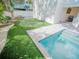 Backyard featuring a putting green, a BBQ grill, and refreshing pool with an adjoined spa at 111 6Th N St, Bradenton Beach, FL 34217