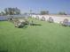Artificial grass covered rooftop deck with seating, tables, and cornhole game at 111 6Th N St, Bradenton Beach, FL 34217