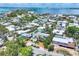 An elevated view displays the home, lush greenery, and a glimpse of the bay and city skyline at 1168 Westway Dr, Sarasota, FL 34236