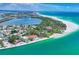 Breathtaking aerial view of a waterfront property with stunning views of the bay and white sandy beaches at 1168 Westway Dr, Sarasota, FL 34236