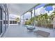 Back porch showcasing a partially covered patio with a lounge area and an outdoor pool surrounded by lush greenery at 1168 Westway Dr, Sarasota, FL 34236