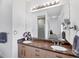 Bright bathroom with double vanity, granite countertop, large mirror, modern fixtures, and tiled shower at 1168 Westway Dr, Sarasota, FL 34236