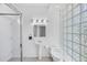 Contemporary bathroom with a glass-enclosed shower, sleek fixtures, and a unique glass block wall at 1168 Westway Dr, Sarasota, FL 34236