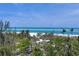 Breathtaking beach view with turquoise waters, white sand, and palm trees for a serene paradise ambiance at 1168 Westway Dr, Sarasota, FL 34236