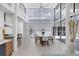 Bright dining space with soaring ceilings, modern decor, large windows, and contemporary furnishings at 1168 Westway Dr, Sarasota, FL 34236