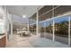 Stunning dining area featuring floor-to-ceiling windows, tile flooring, contemporary table, and sleek lighting at 1168 Westway Dr, Sarasota, FL 34236