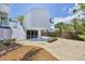 Beautiful home exterior with modern architectural elements and a well-manicured yard at 1168 Westway Dr, Sarasota, FL 34236