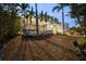 Striking home exterior with lush tropical landscaping enhanced by landscape lighting at 1168 Westway Dr, Sarasota, FL 34236