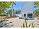 Modern home with a curved exterior, a stone driveway, and views of the pool area and covered patio at 1168 Westway Dr, Sarasota, FL 34236