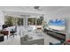 Sunlit living room featuring modern furniture, a large flat-screen TV, and backyard views at 1168 Westway Dr, Sarasota, FL 34236