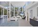 Spacious living room featuring high ceilings, large windows, modern decor, and tiled flooring at 1168 Westway Dr, Sarasota, FL 34236
