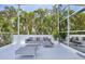 Comfortable patio lounge area with modern furniture and views of lush tropical foliage at 1168 Westway Dr, Sarasota, FL 34236