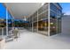 Elegant outdoor patio featuring modern furniture, a dining area, and stunning views through large windows at 1168 Westway Dr, Sarasota, FL 34236