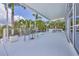 Expansive covered patio with dining and lounging areas, offering great poolside and tropical views at 1168 Westway Dr, Sarasota, FL 34236
