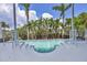 Inviting swimming pool featuring tiered entry steps surrounded by manicured landscaping and a white-railed deck at 1168 Westway Dr, Sarasota, FL 34236
