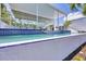 Swimming pool with an integrated water feature surrounded by modern architecture and tropical landscaping at 1168 Westway Dr, Sarasota, FL 34236