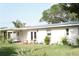 Inviting backyard featuring a cozy outdoor lounge, lush green lawn, and meticulous landscaping at 1207 65Th Nw St, Bradenton, FL 34209