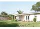 Secluded backyard featuring a quaint outdoor seating area, lush green lawn, and fresh landscaping at 1207 65Th Nw St, Bradenton, FL 34209