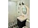Bright bathroom featuring a walk-in shower, checkered tile and stylish mirror, perfect for everyday living at 1207 65Th Nw St, Bradenton, FL 34209