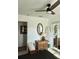 Bright bedroom featuring a ceiling fan, wardrobe and a surfboard, creating a comfortable coastal vibe at 1207 65Th Nw St, Bradenton, FL 34209
