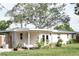 Charming single-story home featuring a covered patio, outdoor shower, and meticulously manicured landscaping at 1207 65Th Nw St, Bradenton, FL 34209