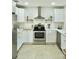 Well-lit kitchen boasting stainless steel appliances, white cabinets, stone countertops, and modern fixtures at 1207 65Th Nw St, Bradenton, FL 34209