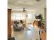 Bright living room featuring neutral paint, ceiling fan, and views to front yard through large windows at 1207 65Th Nw St, Bradenton, FL 34209