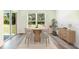 Inviting dining area featuring a round table, comfortable chairs, and sliding glass doors leading to the backyard at 12071 Mountain Island Trl, Parrish, FL 34219