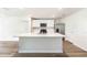 Modern kitchen featuring stainless steel appliances, a large island and sleek floors at 12071 Mountain Island Trl, Parrish, FL 34219