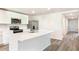 Well-lit kitchen with stainless steel appliances, a large island and sleek floors at 12071 Mountain Island Trl, Parrish, FL 34219