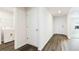 Hallway with a door to the laundry room featuring a washer and dryer set at 12071 Mountain Island Trl, Parrish, FL 34219