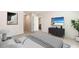 Spacious main bedroom with a TV, dresser, and en-suite bathroom entrance at 12071 Mountain Island Trl, Parrish, FL 34219