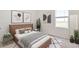 Comfortable bedroom with a bed, artwork, potted plants, bedside tables, and a modern interior design at 12112 Wild Blue Pl, Parrish, FL 34219