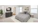 Cozy bedroom with natural light, modern furniture, neutral tones, and an ensuite bathroom at 12112 Wild Blue Pl, Parrish, FL 34219