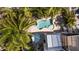 Aerial shot showcases a private pool, outdoor lounge area, lush greenery, and proximity to the home at 123 52Nd St # B, Bradenton Beach, FL 34217