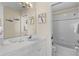 Clean bathroom featuring white vanity, mirror, shower-tub combination with tiled walls at 123 52Nd St # B, Bradenton Beach, FL 34217